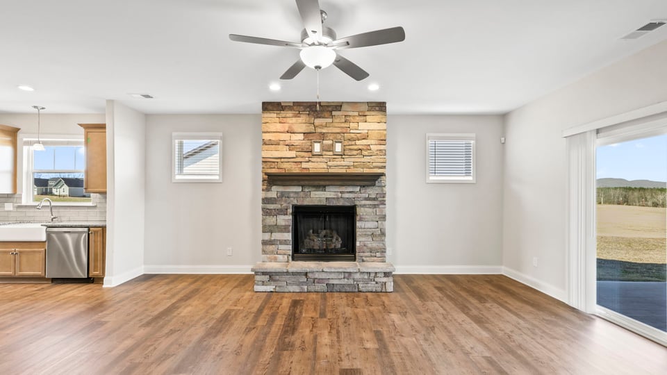 Living area with fireplace and windows.