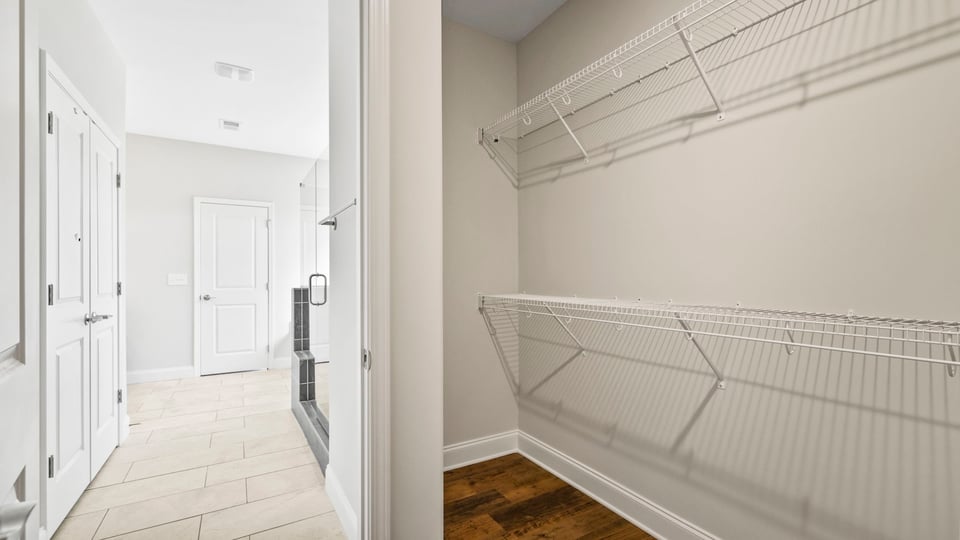 Primary closet with shelves.