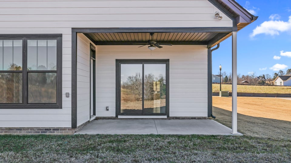 Back exterior with covered porch.
