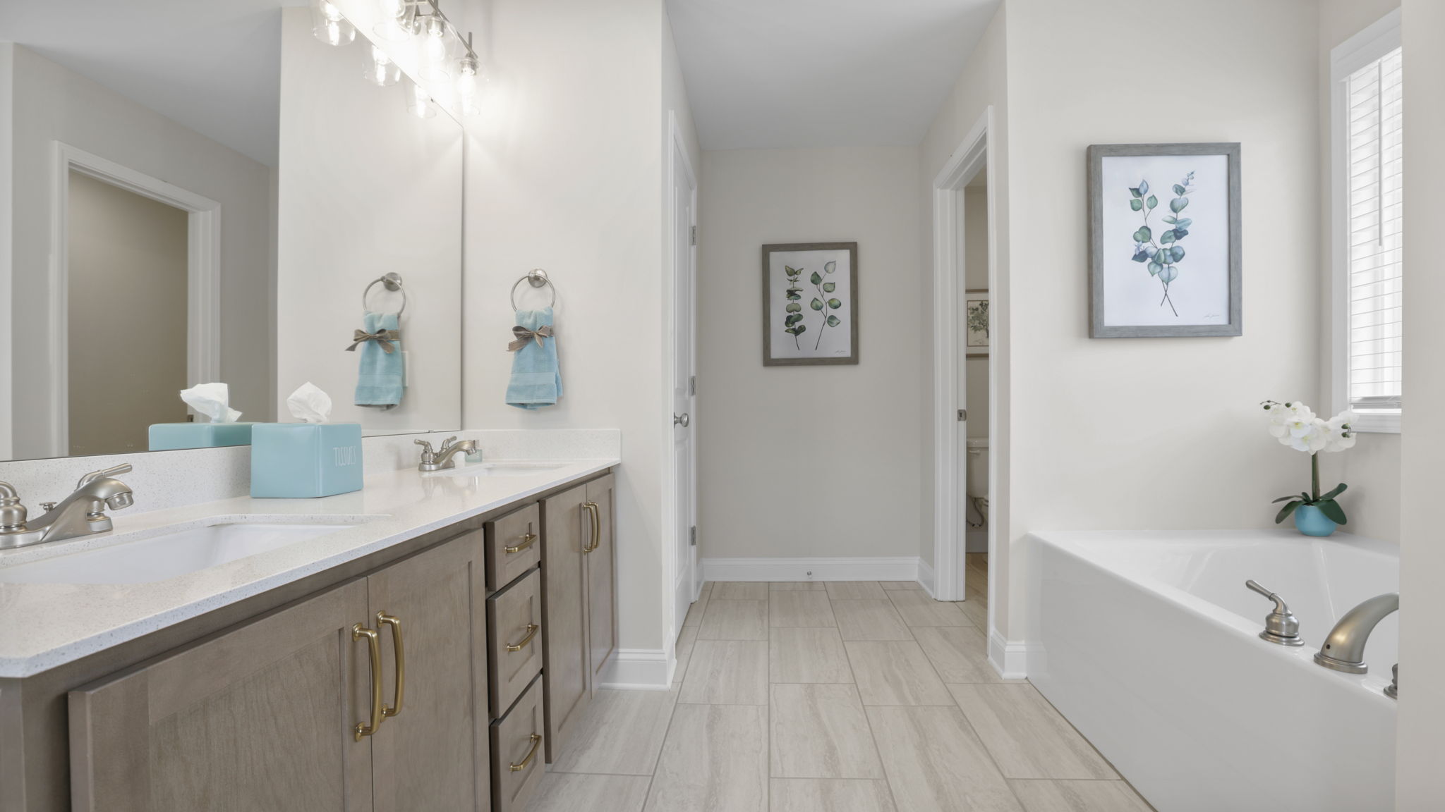 Bathroom with double vanity sink and tub.