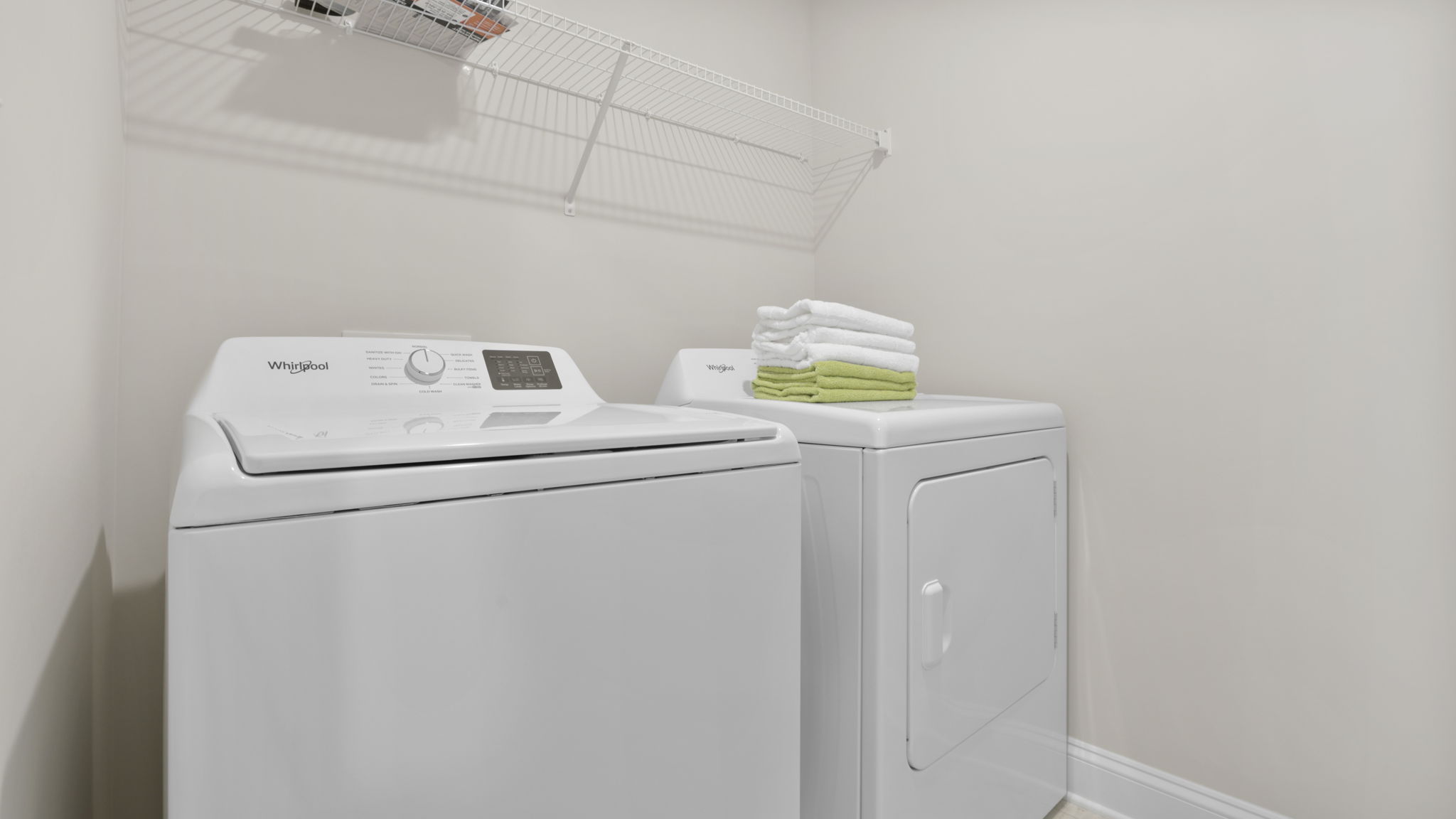 Laundry room with hanging storage racks.