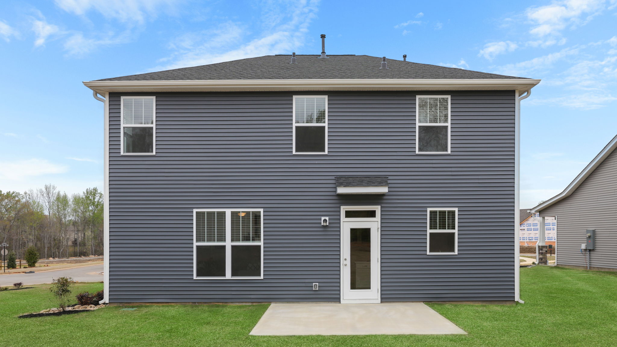 Back exterior of home with large backyard.
