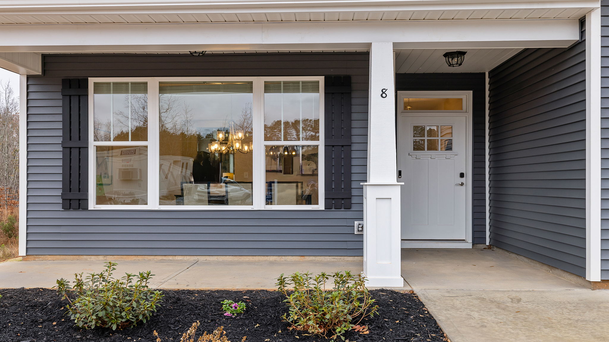 Front porch with windows and front door.