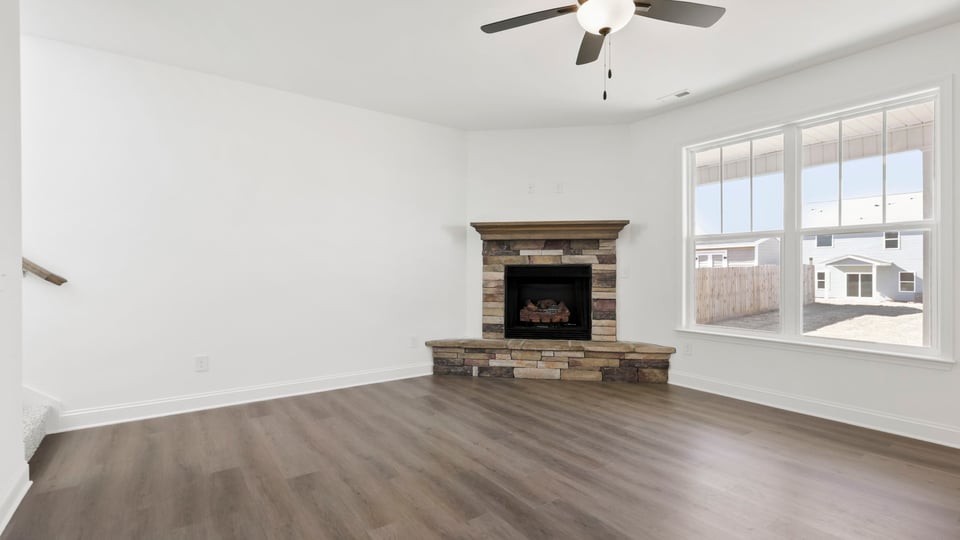 Living room with fireplace and windows.