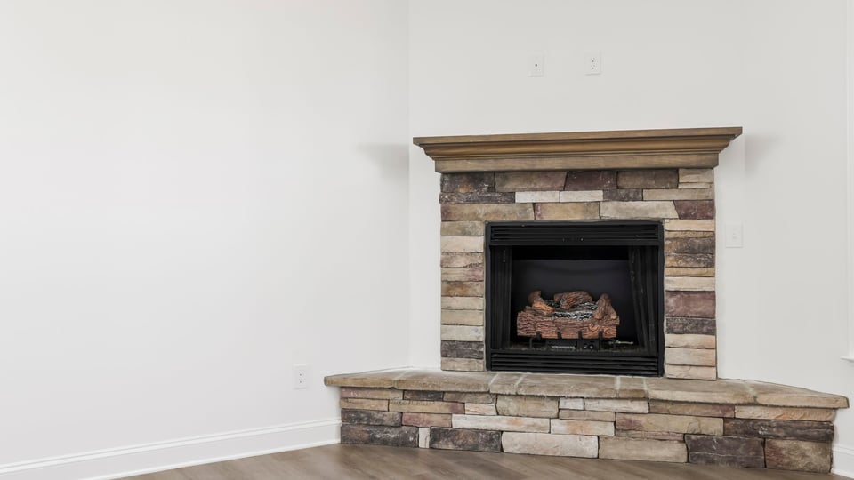 Living room with fireplace and windows.