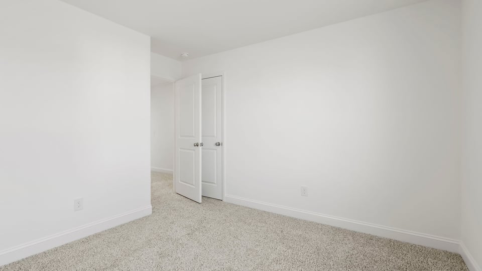Bedroom with carpet and windows.