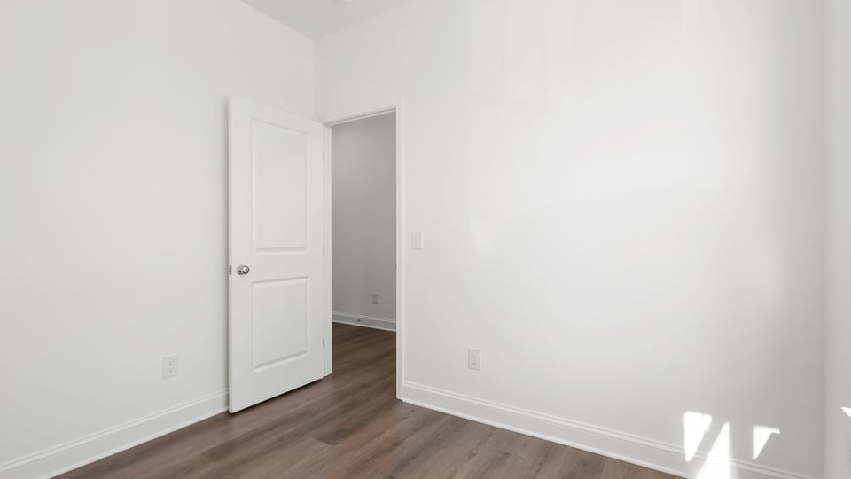 Bedroom with closet and window.