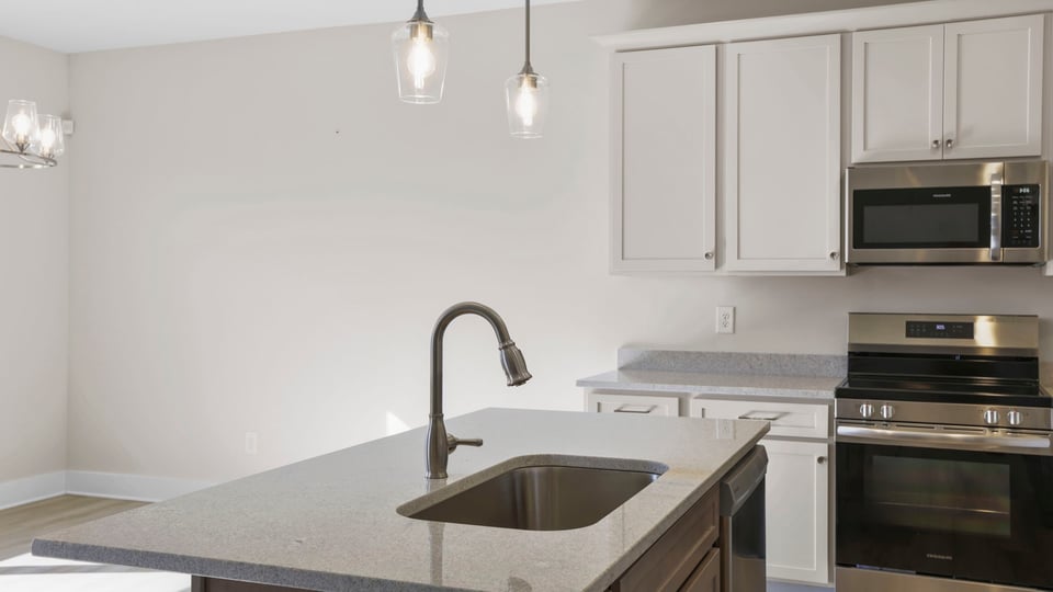 Kitchen with island and cabinets.
