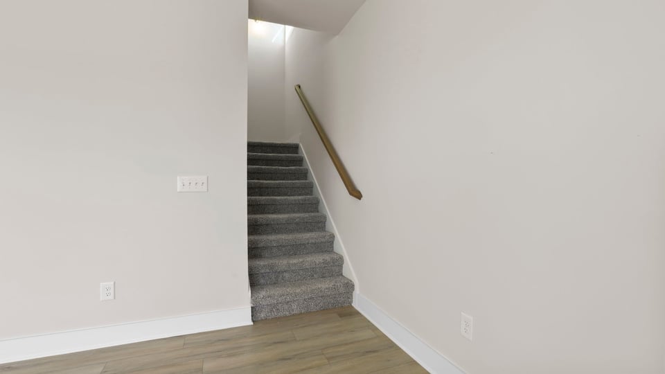 Stairs to second level with carpet.