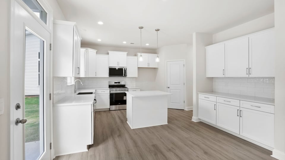 Kitchen and island with quartz countertops.