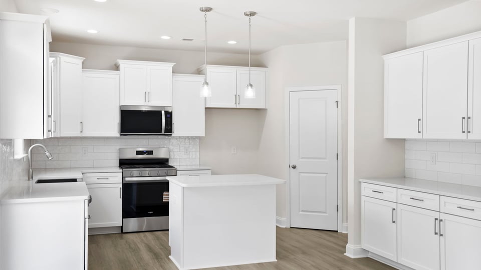 Kitchen and island with quartz countertops.