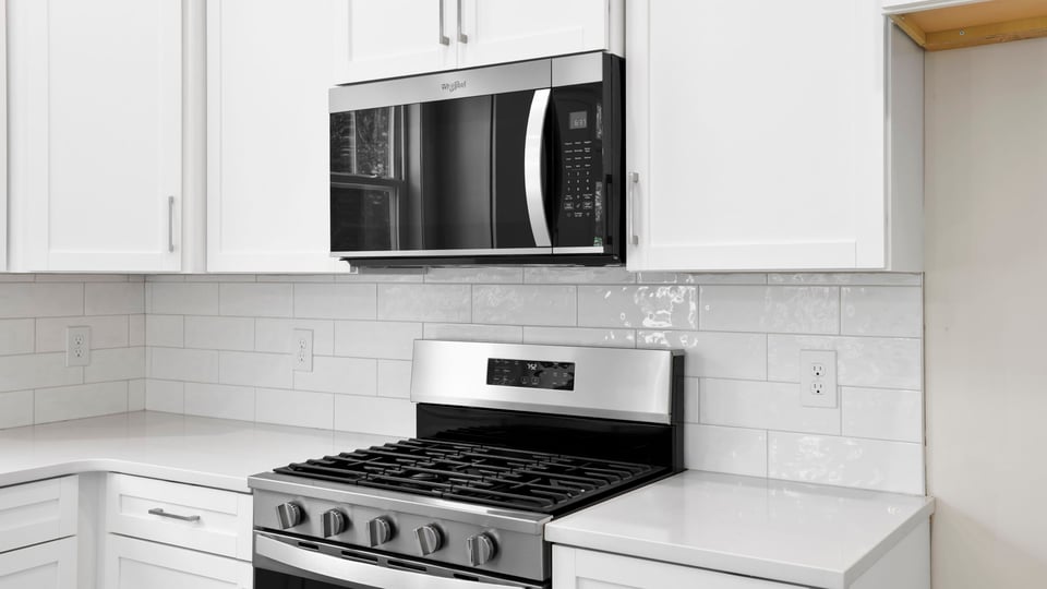 Kitchen and island with quartz countertops.