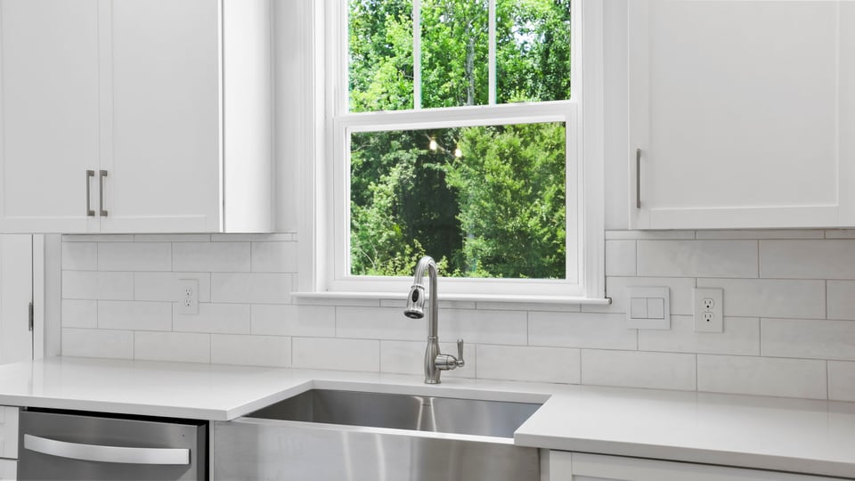 Kitchen and island with quartz countertops.