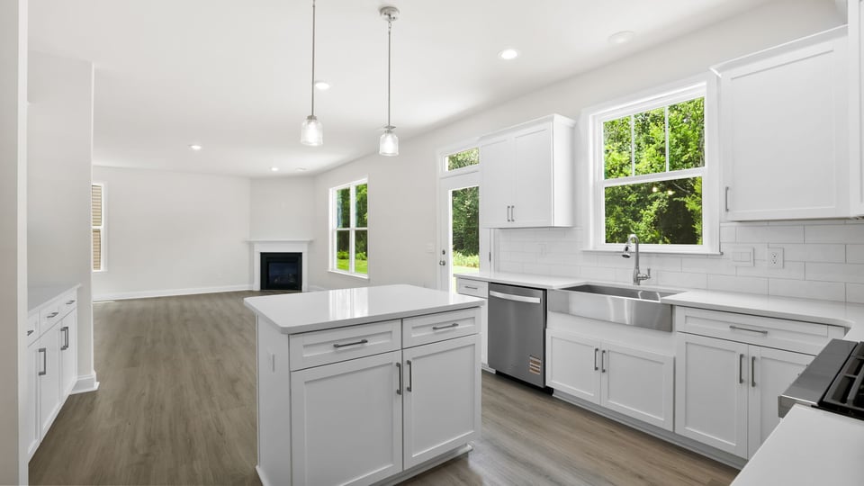 Kitchen and island with quartz countertops.