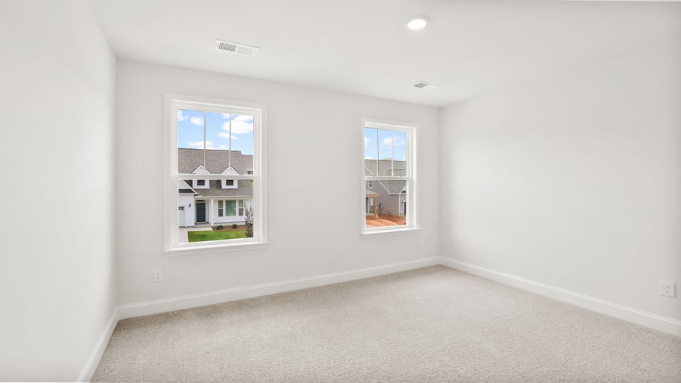Bedroom with carpet and window.