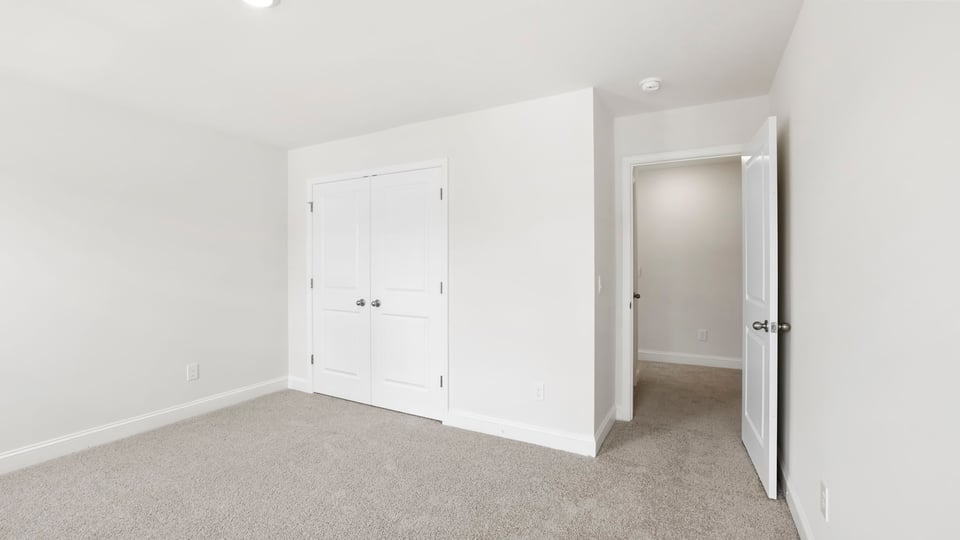 Bedroom with carpet and window.