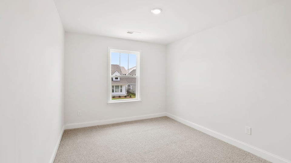 Bedroom with carpet and window.