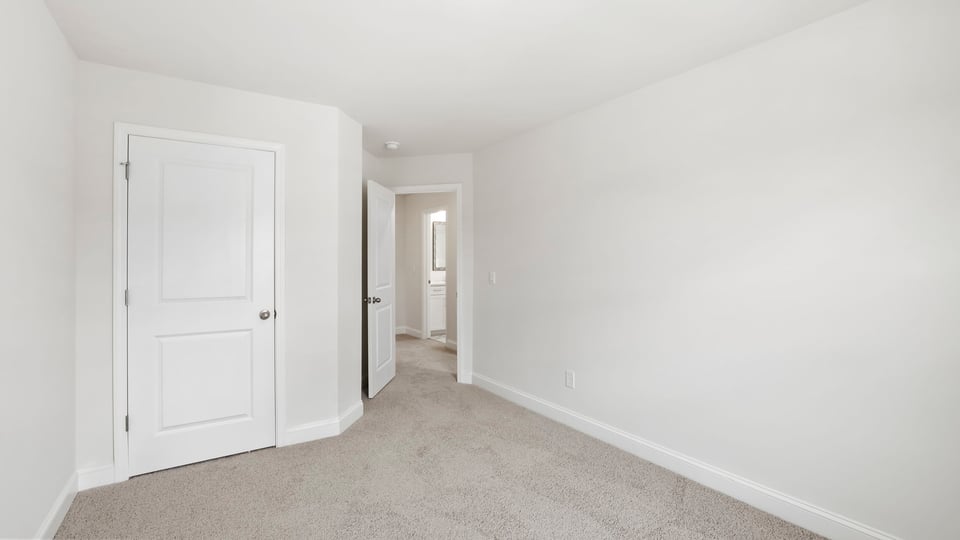 Bedroom with carpet and window.