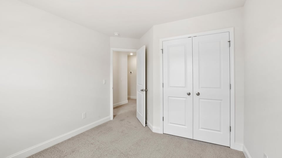 Bedroom with carpet and window.