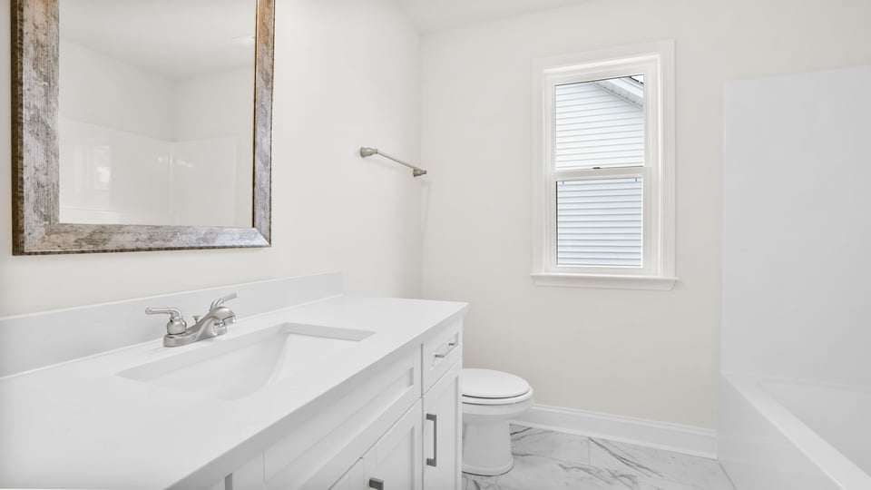 Bathroom with single vanity sink and bathtub.
