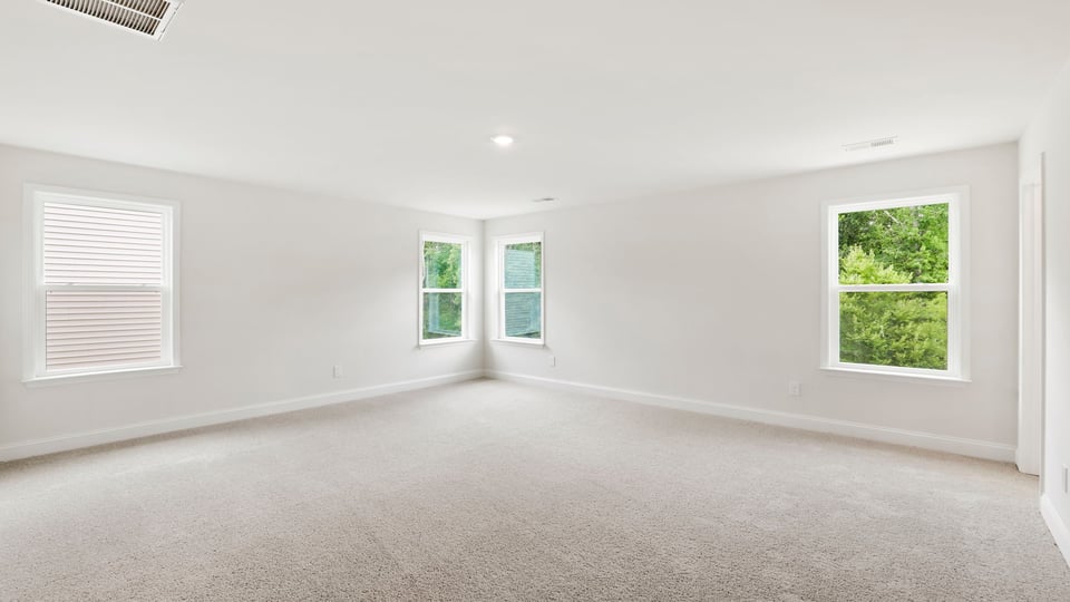 Bedroom with carpet and window.
