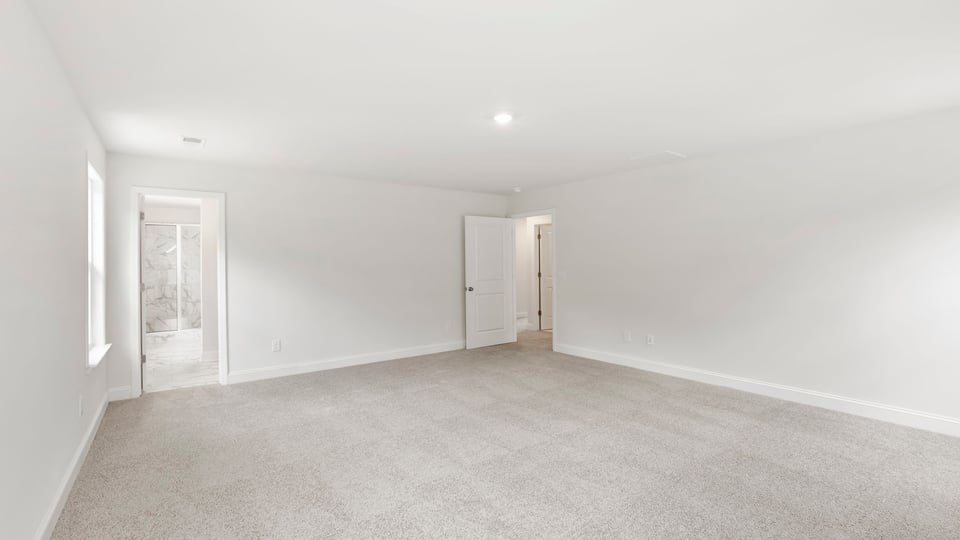 Bedroom with carpet and window.