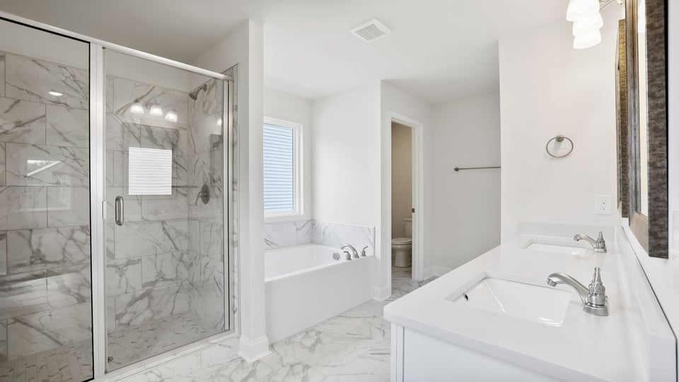 Bathroom with walk in shower and bathtub.