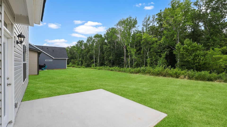 Back exterior of home with patio.