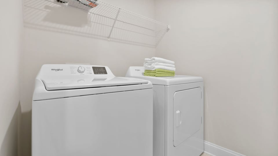 Laundry room with hanging storage racks.