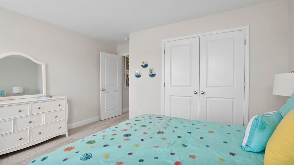 Bedroom with carpet and window.