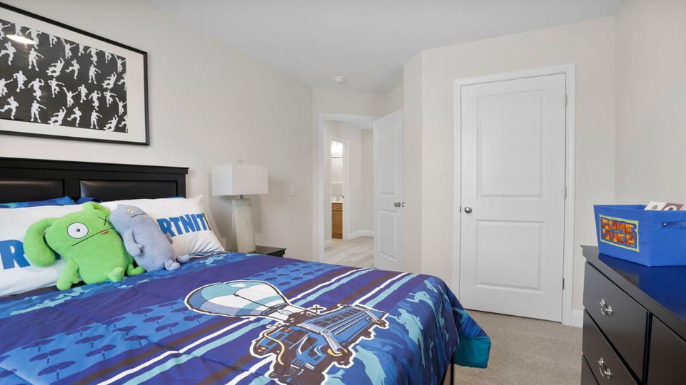 Bedroom with carpet and window.