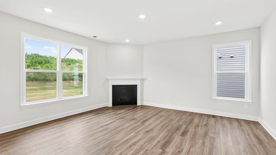 Family room with fireplace and windows.
