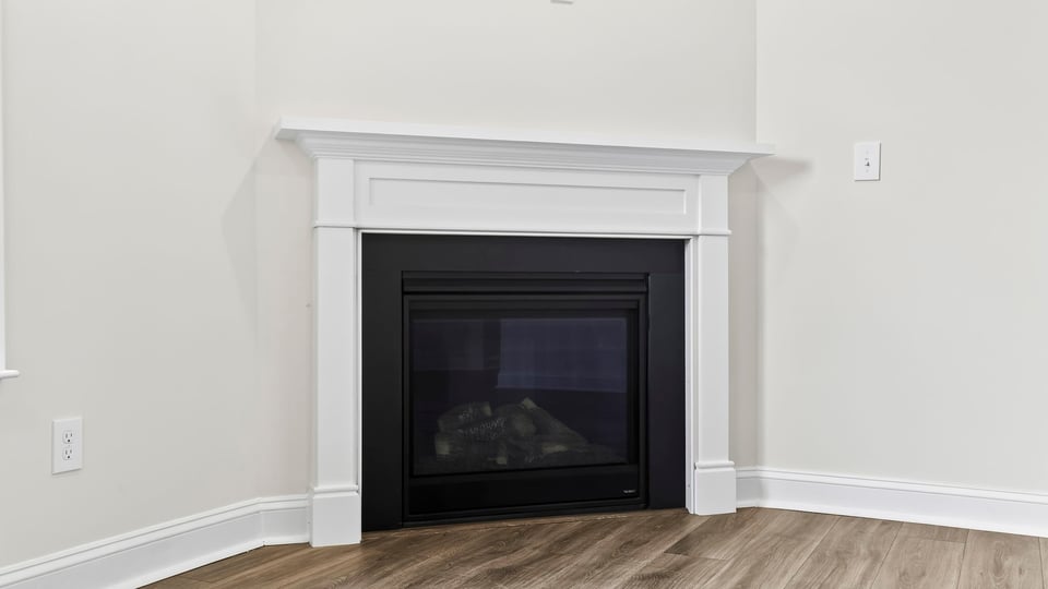 Family room with fireplace and windows.