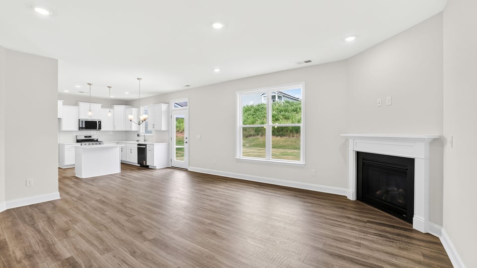 Family room with fireplace and windows.