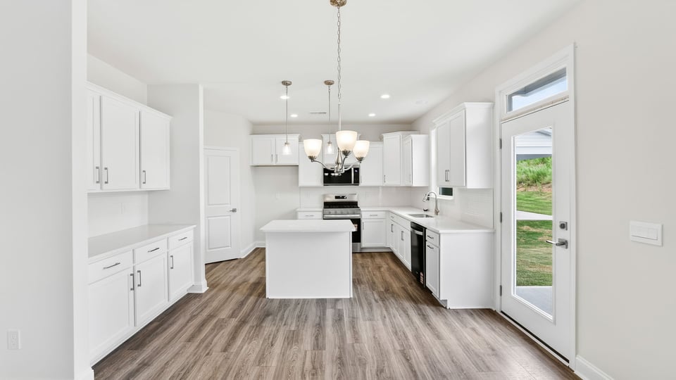 Kitchen and island with quartz countertops.