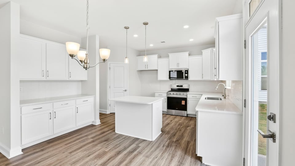 Kitchen and island with quartz countertops.