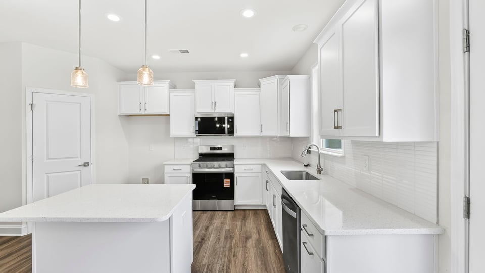 Kitchen and island with quartz countertops.