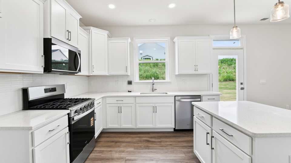 Kitchen and island with quartz countertops.