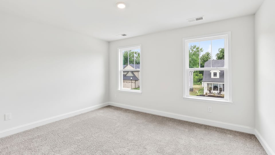 Bedroom with carpet and window.