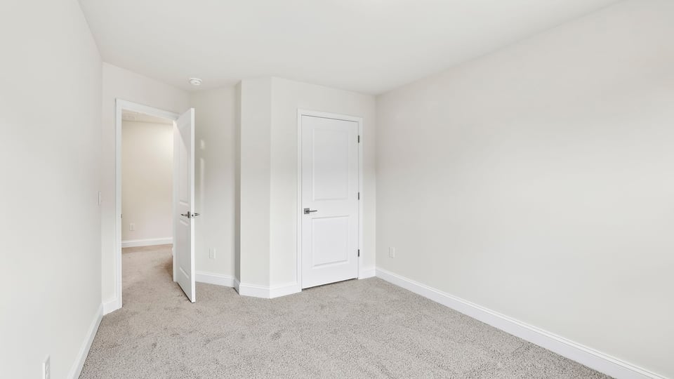 Bedroom with carpet and window.