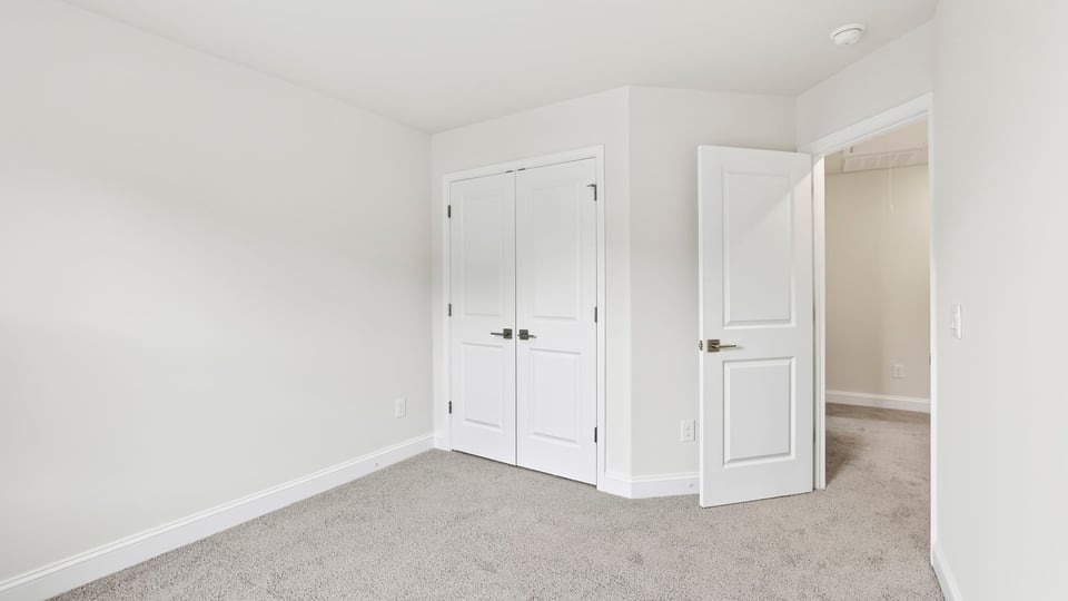 Bedroom with carpet and window.