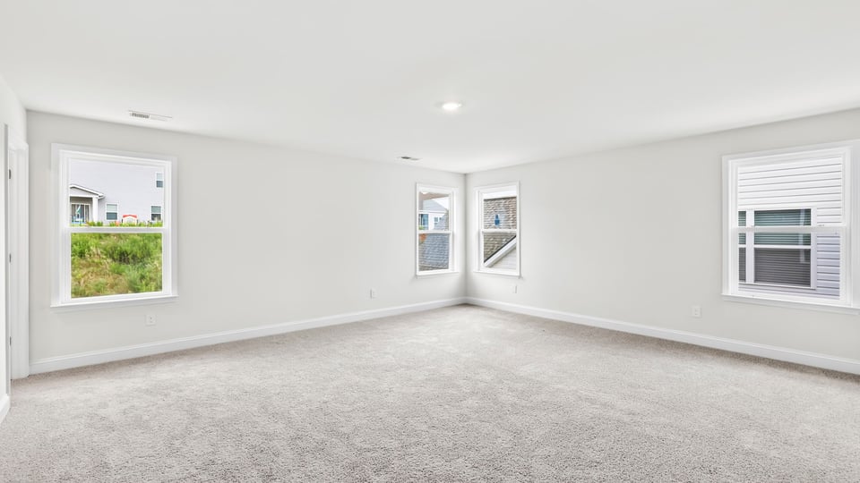 Bedroom with carpet and window.