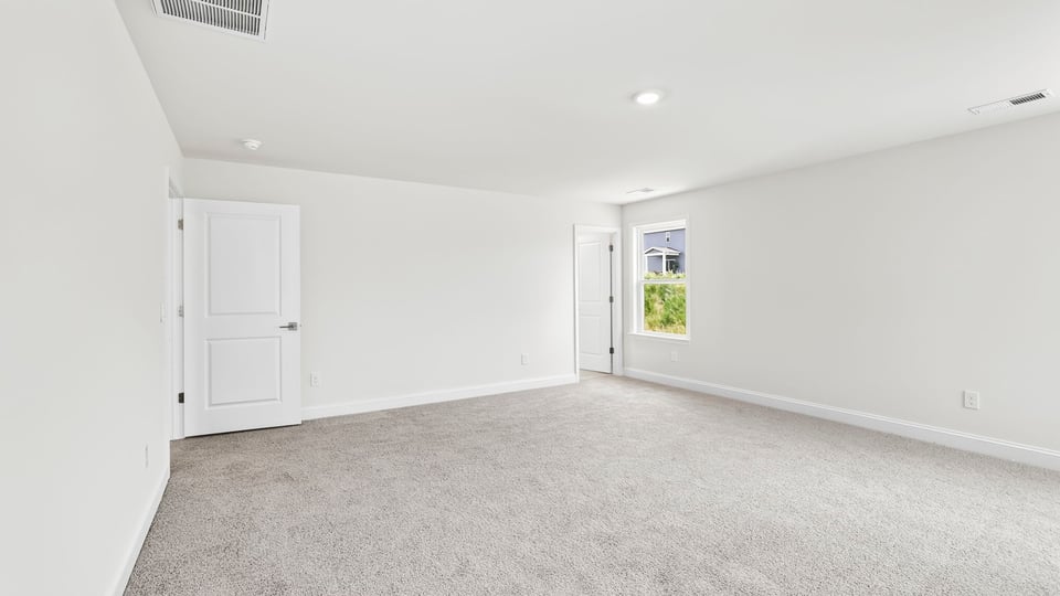 Bedroom with carpet and window.