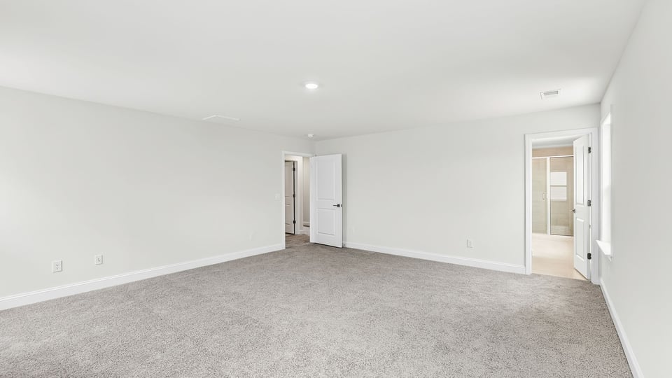 Bedroom with carpet and window.
