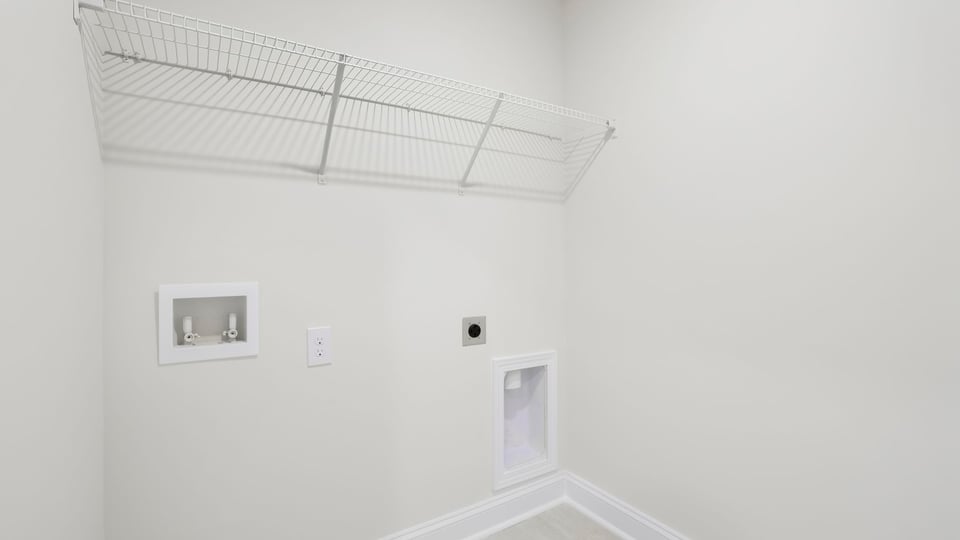 Laundry room with hanging storage racks.