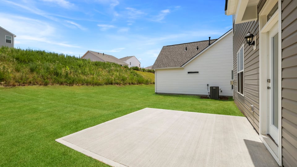 Back exterior of home with patio.