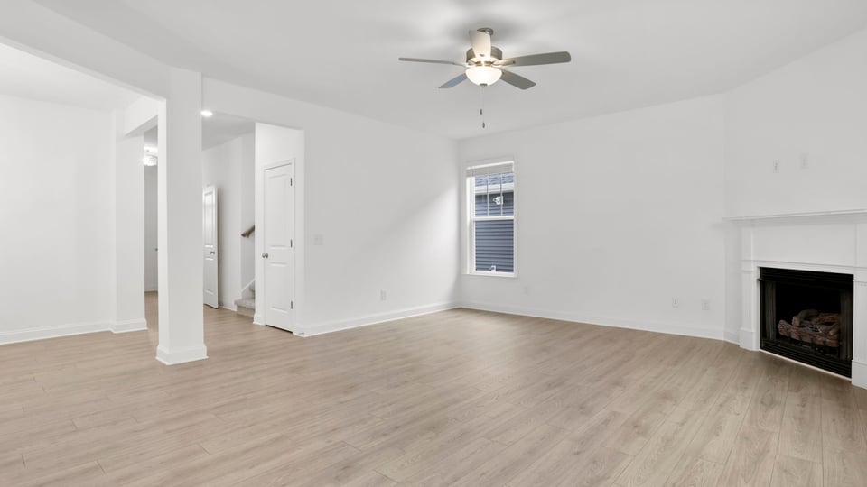 Living area with fireplace and windows.