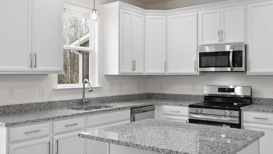 Kitchen with island and cabinets.