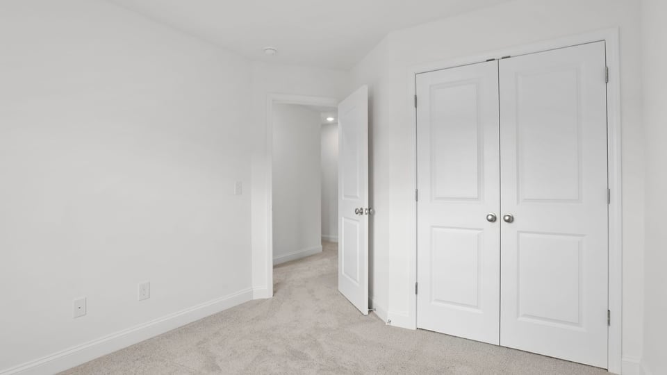 Bedroom with carpet and windows.