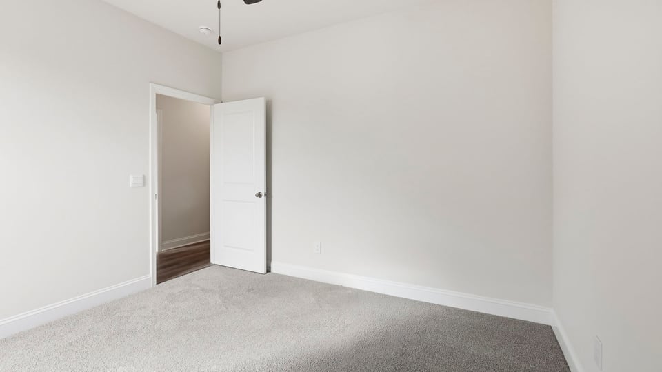 Bedroom with carpet and windows.